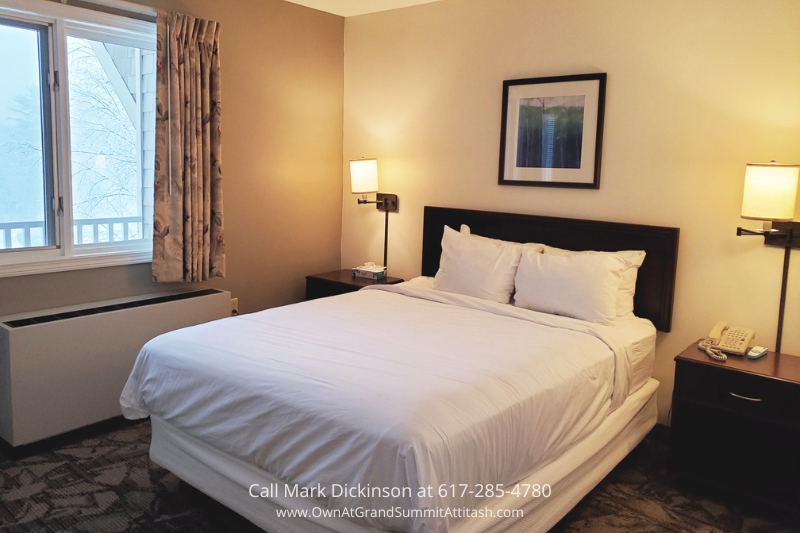 a hotel room with a bed and a window