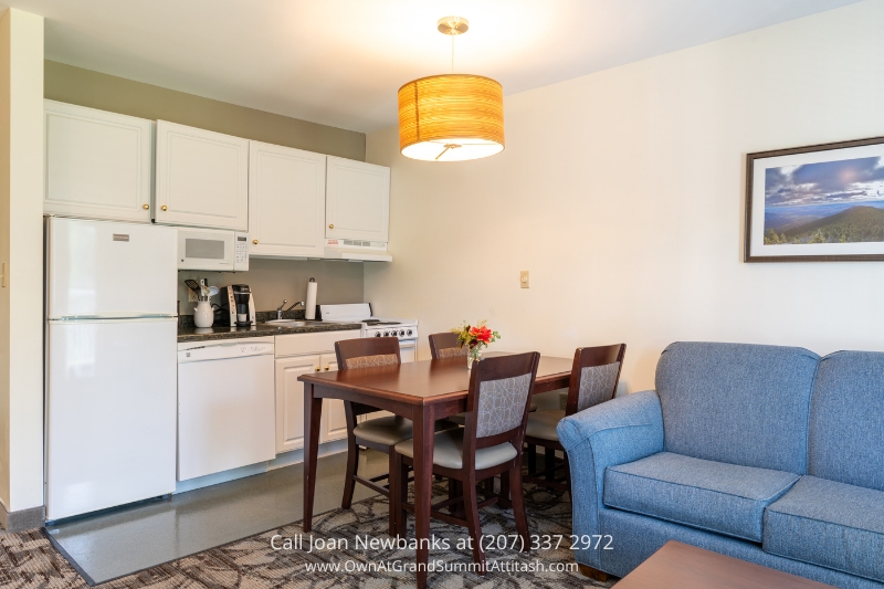 a kitchen and living room with a couch and a table