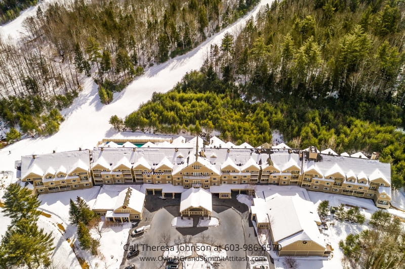 Aerial view of the Grand Summit Hotel at 104 Grand Summit Road, Bartlett, NH, showing the expansive snow-covered grounds and ski trails. Ideally situated for winter sports, this view highlights the prime location of Unit 149 Interval 4.