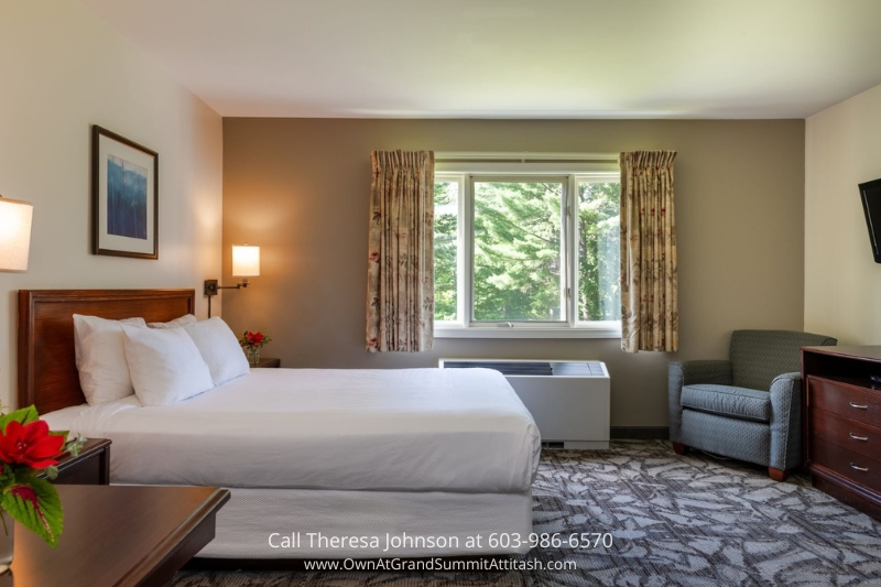 Cozy and well-lit bedroom in Unit 149 Interval 4 at the Grand Summit Hotel, Bartlett, NH, with a large window overlooking the surrounding greenery. Ideal for a comfortable and peaceful stay.