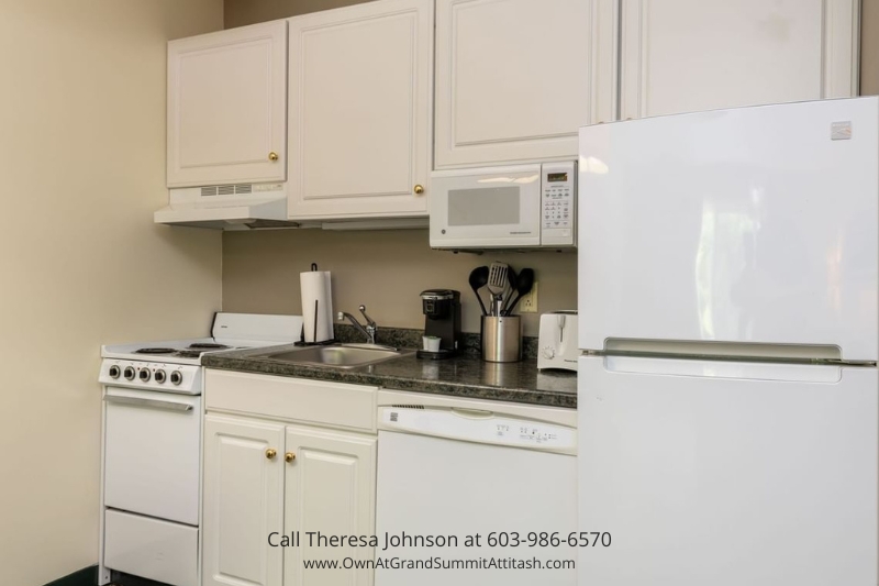 Fully equipped kitchen in Unit 149 Interval 4 at the Grand Summit Hotel, Bartlett, NH, featuring modern appliances, white cabinetry, and a clean countertop, providing convenience for guests.