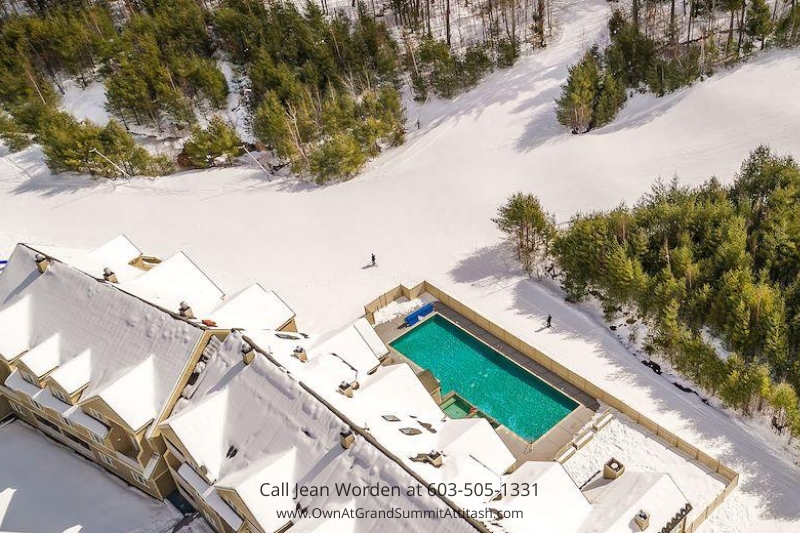 Aerial view of the Bartlett NH Resort Living Unit, surrounded by snow-covered land and tall trees, showcasing the resort's location and private pool in the winter season.