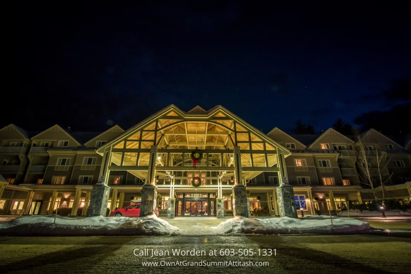 Exterior view of the Bartlett NH Resort Living Unit, capturing the front of the building with snow covering the ground and welcoming entrance illuminated at night.
