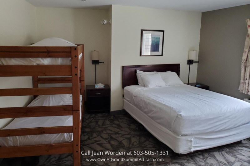 Studio apartment layout in the Bartlett NH Resort Living Unit, with a spacious bed, a bunk bed for additional sleeping arrangements, and cozy furniture for a pleasant stay.